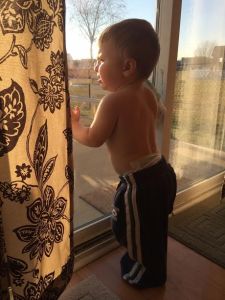 Just one man, staring down the world. (Or just a fat little toddler watching the birds outside...but you get the idea).