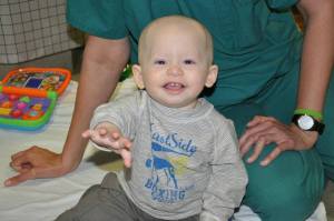 Xander playing in his hospital room, still with a smile on his face.